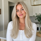 18-inch platinum blonde wavy clip-in hair extension worn in a bright kitchen