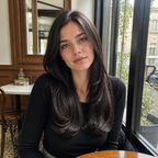 18-inch black wavy clip-in hair extension worn beside a cafe window