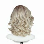 Back view of rooted platinum blonde 9-inch loose curly bob wig