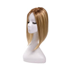14-inch rooted champagne blonde straight hair topper on a mannequin, showing the parting and shape