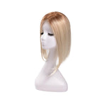 14-inch rooted platinum blonde straight hair topper on a mannequin, showing the parting and shape