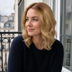14-inch rooted champagne blonde wavy hair topper worn on a wrought-iron balcony