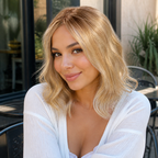 14-inch rooted pastel blonde wavy hair topper worn at an outdoor cafe