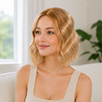 12-inch honey blonde wavy hair topper worn beside a window