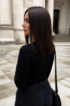 13-inch auburn brown straight long bob wig worn from behind in a stone courtyard